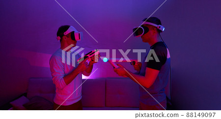 Two friends are playing virtual reality games and fighting each other. 88149097