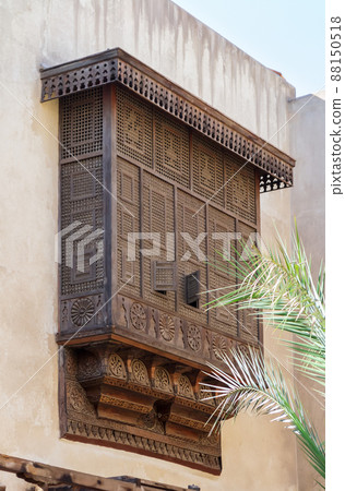 Mamluk era style oriel window covered by interleaved wooden grid (Mashrabiya) on stone wall, Cairo, Egypt Mamluk era style oriel window covered by interleaved wooden grid (Mashrabiya) on stone wall, Cairo, Egypt 88150518