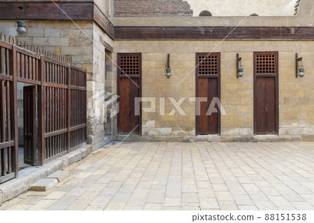 Three adjacent doors in a stone bricks wall and wooden fence, Sultan Al Nassir Qalawun Mosque Three adjacent doors in a stone bricks wall and wooden fence, Sultan Al Nassir Qalawun Mosque 88151538