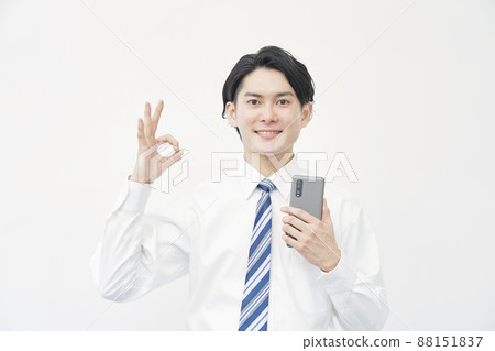 Businessman has a smartphone OK white background Businessman has a smartphone OK white background 88151837