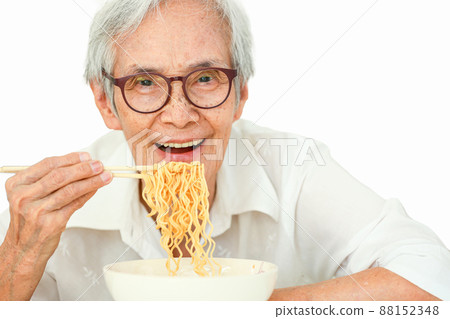 Beautiful happy old elderly people eating instant noodles with wooden chopsticks,Smiling asian senior woman eating delicious hot and spicy instant food,looking at camera,isolated on white background Beautiful happy old elderly people eating instant noodles with wooden chopsticks,Smiling asian senior woman eating delicious hot and spicy instant food,looking at camera,isolated on white background 88152348