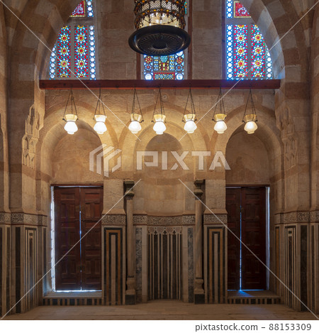Marble wall with mihrab (niche), wooden doors, huge arches and stained glass windows, Khayer Bek Mausoleum, Old Cairo, Egypt Marble wall with mihrab (niche), wooden doors, huge arches and stained glass windows, Khayer Bek Mausoleum, Old Cairo, Egypt 88153309