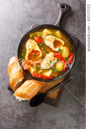 Portuguese fish stew Caldeirada de Peixe close-up in a bowl. Vertical top view Portuguese fish stew Caldeirada de Peixe close-up in a bowl. Vertical top view 88153522