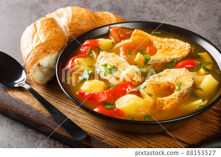 Caldeirada de peixe made of onions, garlic, tomatoes, red peppers, stock, white wine, and white fish close-up in a bowl. Horizontal Caldeirada de peixe made of onions, garlic, tomatoes, red peppers, stock, white wine, and white fish close-up in a bowl. Horizontal 88153527