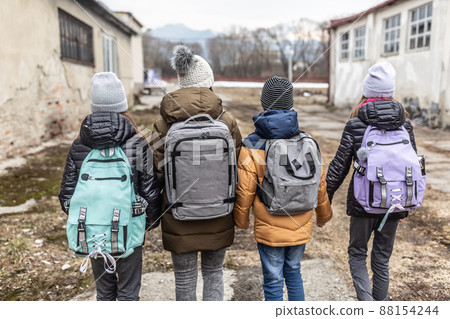 Woman flees the conflict with Russia with three kids in a derelict surroundings 88154244