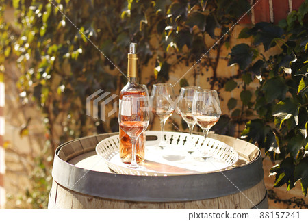 Many glasses and bottle of rose wine in the autumn vineyard 88157241