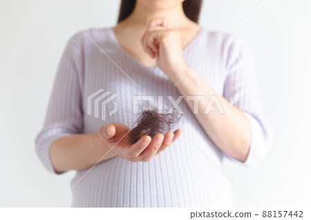 Pregnant women suffering from hair loss 88157442
