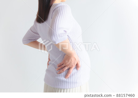 Pregnant woman arching her back 88157460