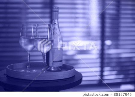 Two glasses of white wine and bottle in the restaurant on blurred background 88157945