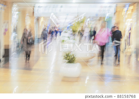 Abstract defocused motion blurred people, walking in shopping center, urban lifestyle concept Abstract defocused motion blurred people, walking in shopping center, urban lifestyle concept 88158768