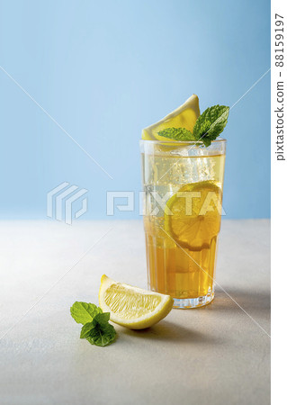 Iced tea with lemon and fresh mint, blue - Stock Photo