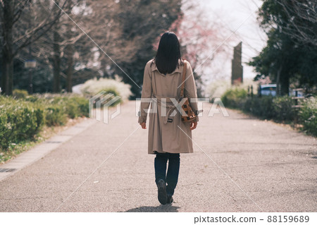 Back view of a woman in a spring trench coat Back view of a woman in a spring trench coat 88159689