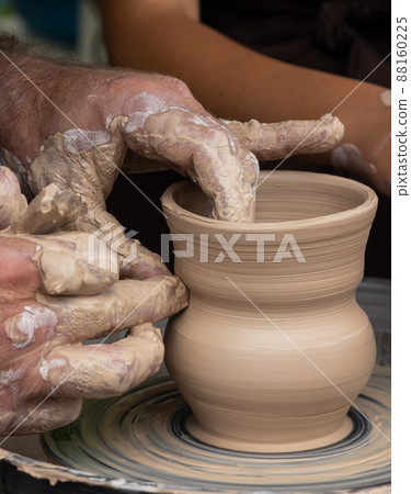 Master class on modeling of clay on a potter's wheel In the pottery workshop Master class on modeling of clay on a potter's wheel In the pottery workshop 88160225