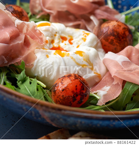 Buratta salad with tomatoes and prosciutto or jamon. Buratta salad with tomatoes and prosciutto or jamon. 88161422
