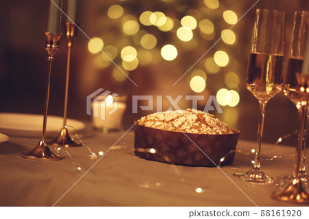Freshly baked panettone cake above table served for festive dinner, photo in rustic style. Freshly baked panettone cake above table served for festive dinner, photo in rustic style. 88161920