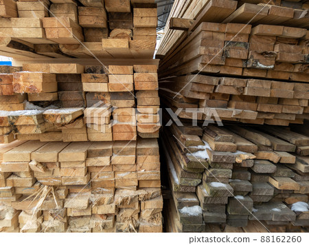 wooden boards storage under a canopy with snow and metled ice on the floor wooden boards storage under a canopy with snow and metled ice on the floor 88162260