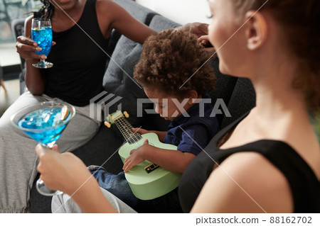 Toddler Boy Playing Ukulele 88162702