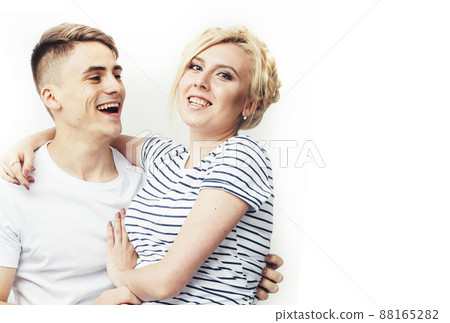 young pretty teenage couple, hipster guy with his girlfriend happy smiling and hugging isolated on white background, lifestyle people concept young pretty teenage couple, hipster guy with his girlfriend happy smiling and hugging isolated on white background, lifestyle people concept 88165282