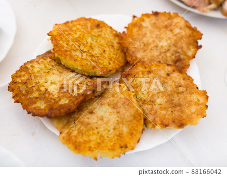 Potato pancakes with sour cream on white plate 88166042