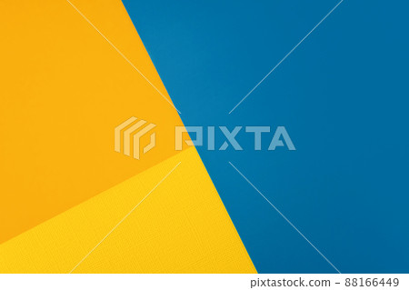 Bright abstract geometric paper background. Yellow, orange and blue trendy colors. The backdrop for an invitation card, greeting card or web design. Creative copy space, flat lay Bright abstract geometric paper background. Yellow, orange and blue trendy colors. The backdrop for an invitation card, greeting card or web design. Creative copy space, flat lay 88166449