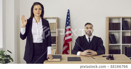 Witness swears on the Bible before giving a testimony during a trial in American court Witness swears on the Bible before giving a testimony during a trial in American court 88166766