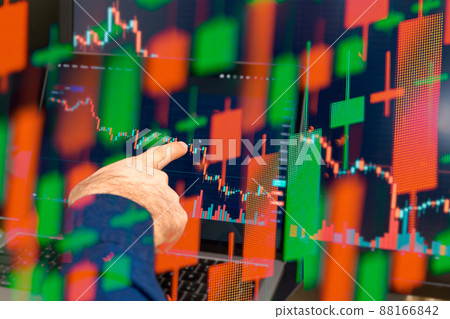 Global downtrend of the economy in world crisis. Man hand shows on the decreasing candle stick graph chart in the stock market, March 2022, San Francisco, USA 88166842