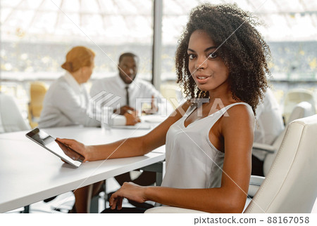 African businesswoman sitting at office room using tablet African businesswoman sitting at office room using tablet 88167058