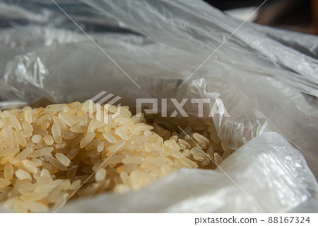 Dry rice in a plastic bag close-up. Culinary theme. Selective focus. Dry rice in a plastic bag close-up. Culinary theme. Selective focus. 88167324