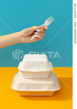Lunchbox and womans hand with fork on orange table. Food delivery concept 88167549