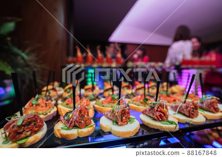Decorated catering banquet table with different food snacks and appetizers with sandwich 88167848