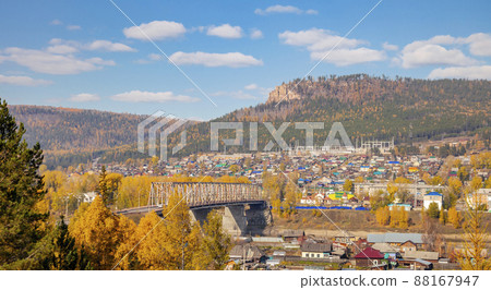 Autumn taiga landscape with bridge over the Lena River in Ust-Kut. Autumn taiga landscape with bridge over the Lena River in Ust-Kut. 88167947