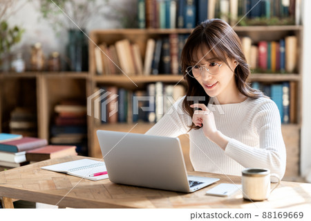 Woman with glasses having an online meeting in a chic room Woman with glasses having an online meeting in a chic room 88169669