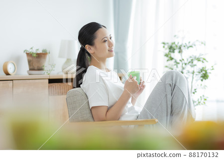 A young lady sitting on the sofa A young lady sitting on the sofa 88170132