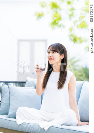 A young woman drinking mineral water A young woman drinking mineral water 88170178