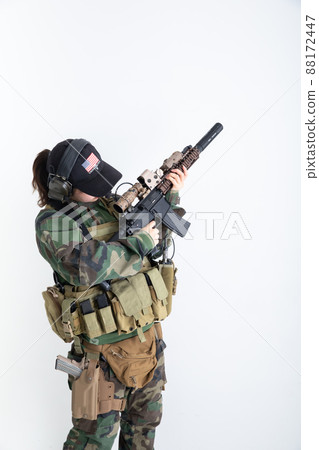 Female soldier holding a gun Female soldier holding a gun 88172447