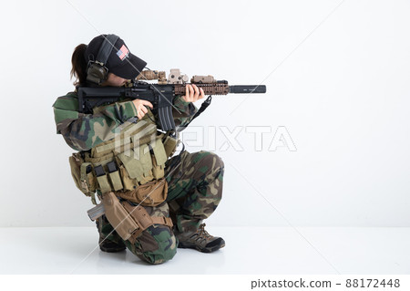 Female soldier holding a gun Female soldier holding a gun 88172448
