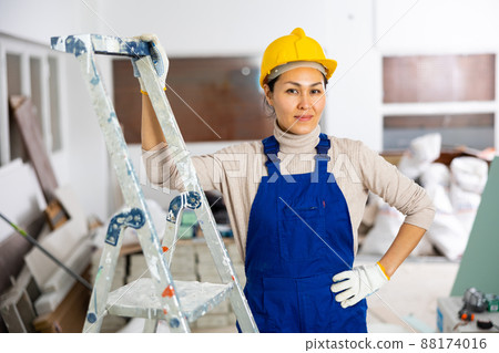 Woman foreman checks the completed construction work on drawing Woman foreman checks the completed construction work on drawing 88174016