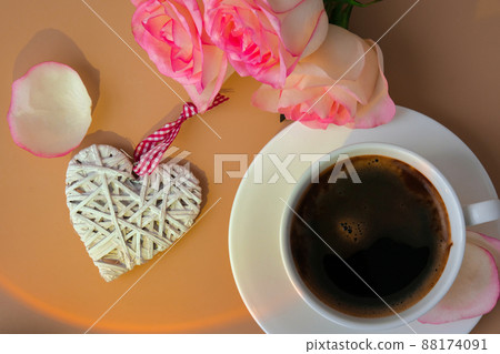 Tender pink rose on vase with white cup of coffee on beige background. Minimal composition. Romantic pastel pink rose flower. Modern aesthetic. Neutral earth tones. Holiday morning breakfast Hardlight 88174091