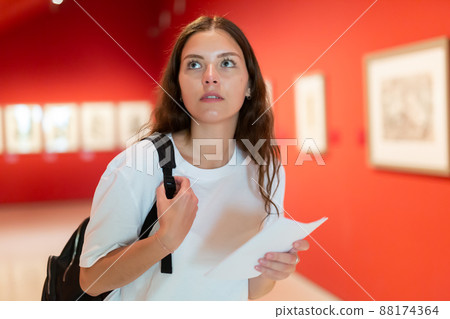 Focused girl visitor, admirins the paintings in the museum 88174364