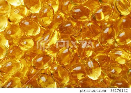 Golden Vitamin D3 Capsules close-up in full screen 88176182
