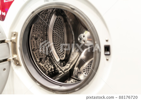 The washing machine drum is dry and clean close-up. Washer 88176720