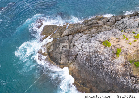 Aerial view Top down seashore big wave crashing on rock cliff Beautiful dark sea surface in sunny day summer background Amazing seascape top view seacoast at Phuket Thailand 88176932