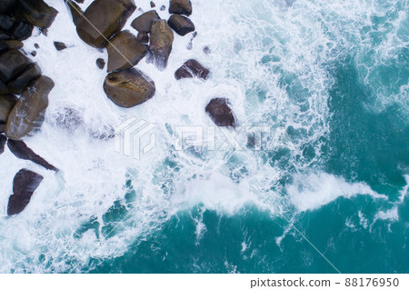 Aerial view Top down seashore big wave crashing on rock cliff Beautiful dark sea surface in sunny day summer background Amazing seascape top view seacoast at Phuket Thailand Aerial view Top down seashore big wave crashing on rock cliff Beautiful dark sea surface in sunny day summer background Amazing seascape top view seacoast at Phuket Thailand 88176950
