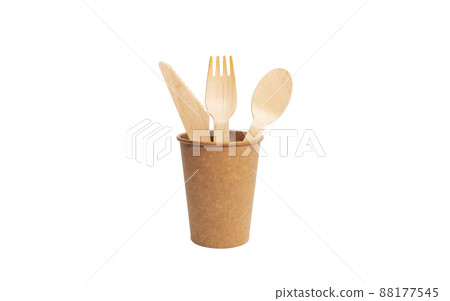 Eco brown cup and wooden khife, fork, spoon on a white background. Mockup for your and copy space Eco brown cup and wooden khife, fork, spoon on a white background. Mockup for your and copy space 88177545