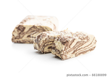 Sweet tahini halva with cocoa flavor . Turkish dessert isolated on white background. Sweet tahini halva with cocoa flavor . Turkish dessert isolated on white background. 88180899