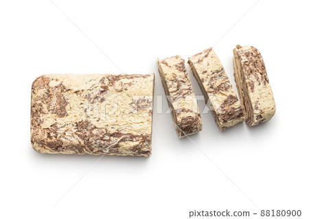 Sweet tahini halva with cocoa flavor . Turkish dessert isolated on white background. Sweet tahini halva with cocoa flavor . Turkish dessert isolated on white background. 88180900