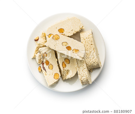 Sweet tahini halva with almonds. Turkish dessert isolated on white background. Sweet tahini halva with almonds. Turkish dessert isolated on white background. 88180907