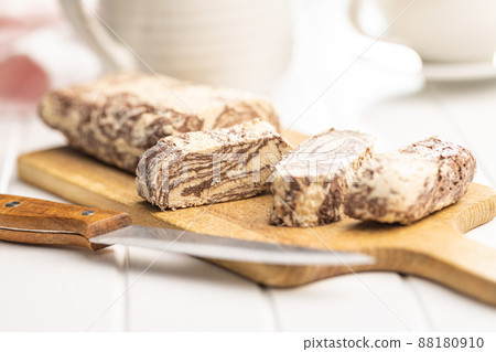 Sweet tahini halva with cocoa flavor. Turkish dessert on cutting board. Sweet tahini halva with cocoa flavor. Turkish dessert on cutting board. 88180910