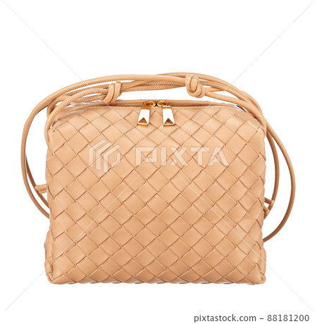 Gorgeous little handbag made of woven beige leather, isolated on a white background. Front view. Expensive women's accessories. Gorgeous little handbag made of woven beige leather, isolated on a white background. Front view. Expensive women's accessories. 88181200