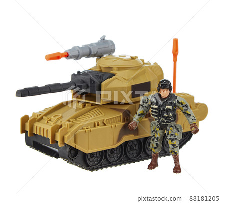 Modern combat toy tank equipped with a large-caliber machine gun, against which stands a soldier in camouflage uniform and helmet, isolated on a white background. Military conflict. Modern combat toy tank equipped with a large-caliber machine gun, against which stands a soldier in camouflage uniform and helmet, isolated on a white background. Military conflict. 88181205